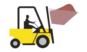 A yellow forklift driven by a person lifts a large, textured, red sheet using its forks, ideal for handling materials in Blast Booths or during Abrasive Media Recovery, with the sheet elevated and tilted forward.